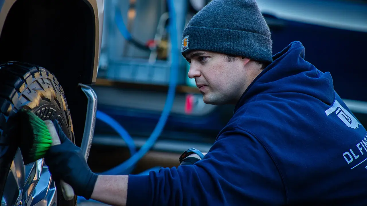 DL Fine Auto owner cleaning wheels